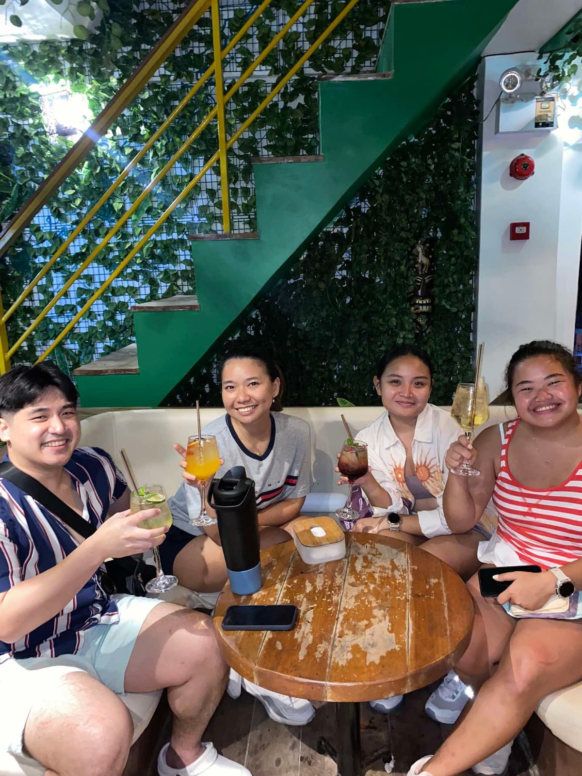 A group of friends toasting cocktails together at Mai Tai Beach Bar Boracay